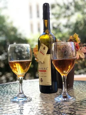 a bottle of wine and two glasses on a table at Apartments Sija in Ulcinj