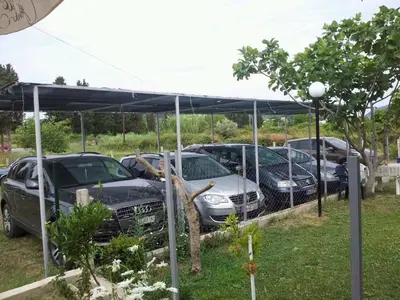 a group of cars parked under a canopy at Apartments Sija in Ulcinj