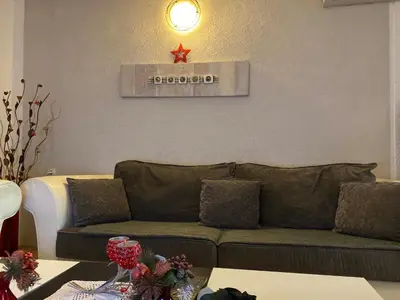a living room with a couch and a star on the wall at Apartments OldTown in Podgorica