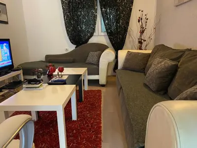 a living room with a couch and a table at Apartments OldTown in Podgorica