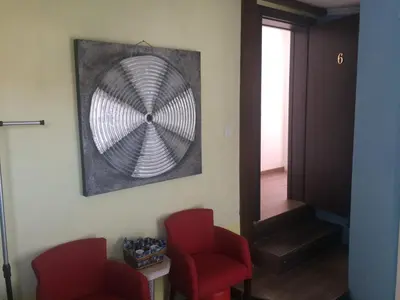 a room with two red chairs and a mirror at Apartments OldTown in Podgorica