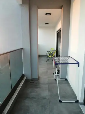 a empty hallway with a table and a chair at Apartmani Seaside in Dobra Voda