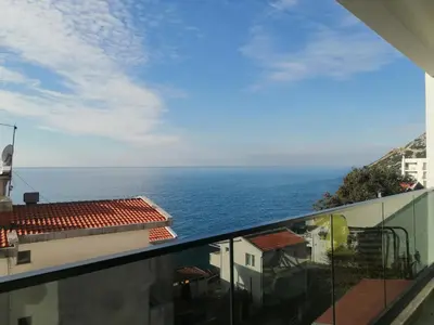 a view of the ocean from a balcony at Apartmani Seaside in Dobra Voda