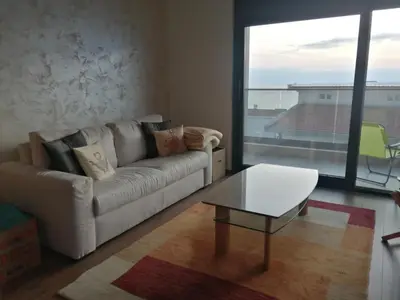 a living room with a couch and a table at Apartmani Seaside in Dobra Voda