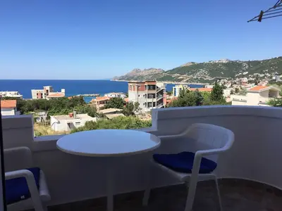 a table and chairs on a balcony with a view of the ocean at Apartments Nurkovic in Dobra Voda