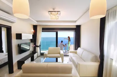a living room with a view of the ocean at Shine residence in Budva