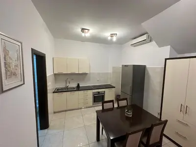 a kitchen with a table and a kitchen with a refrigerator at Shine residence in Budva