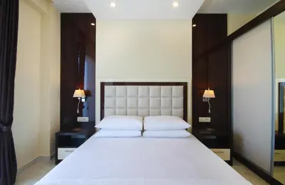 a bedroom with a large white bed with two pillows at Shine residence in Budva