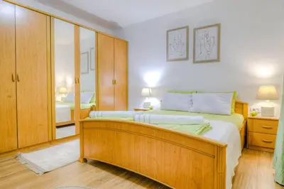 a bedroom with a large bed with a wooden frame at Pavle's Oasis in Virpazar