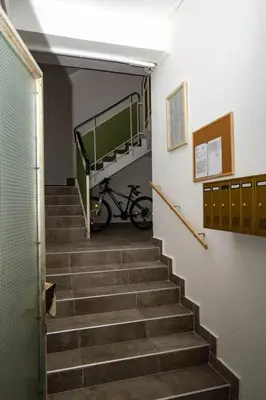 a staircase in a building with a bike on the wall at Milan apartment in Bar