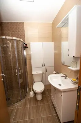 a bathroom with a toilet and a shower and a sink at Milan apartment in Bar