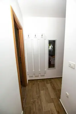 a hallway with white cabinets and a wooden floor at Milan apartment in Bar