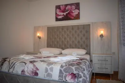 a bedroom with a large bed with two pillows at Guest House Alea in Ulcinj