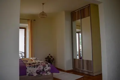 a bedroom with a bed and a large mirror at Guest House Alea in Ulcinj