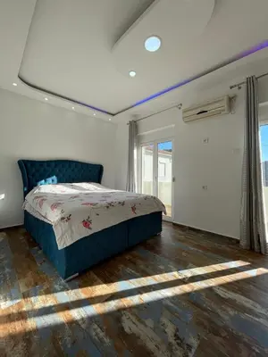 a bedroom with a bed and a large window at Centro apartments and rooms in Ulcinj