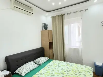 a bedroom with a bed and a window at Centro apartments and rooms in Ulcinj
