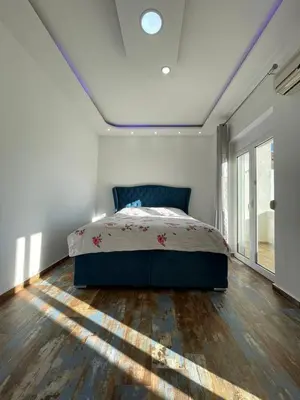a bedroom with a bed and a large window at Centro apartments and rooms in Ulcinj