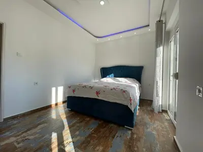 a bedroom with a bed in a room with a ceiling at Centro apartments and rooms in Ulcinj