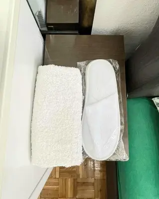 a white towel sitting on a shelf in a room at Centro apartments and rooms in Ulcinj