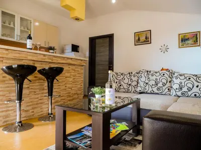 a living room with a couch and a table at Apartments MileS in Utjeha