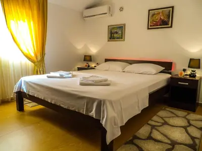 a bedroom with a bed with two towels on it at Apartments MileS in Utjeha