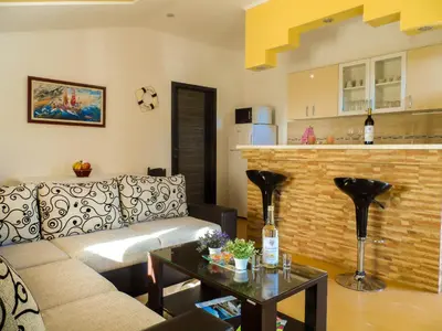 a living room with a couch and a table at Apartments MileS in Utjeha