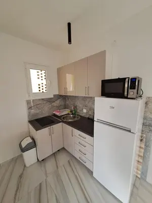 a small kitchen with a sink and a microwave at Apartments MileS in Utjeha