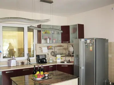 a kitchen with a refrigerator and a counter with a bowl of fruit at Villa Yukka in Utjeha