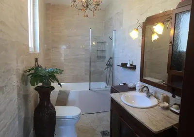 a bathroom with a toilet and a shower and a sink at Villa Yukka in Utjeha