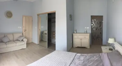 a bedroom with a bed and a couch and a mirror at Villa Yukka in Utjeha