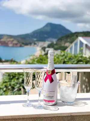 a bottle of champagne and two glasses on a table at Apartments Moracanin in Sutomore