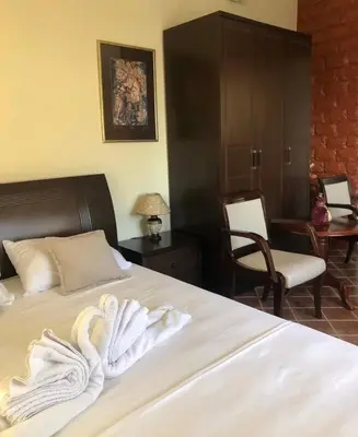 a hotel room with a bed with towels on it at Apartments Moracanin in Sutomore
