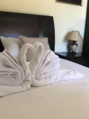 a pile of towels sitting on top of a bed at Apartments Moracanin in Sutomore