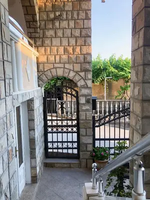 an entrance to a house with a black gate at Apartments Moracanin in Sutomore