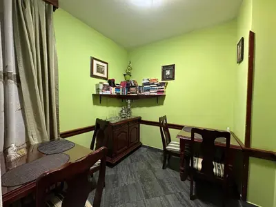 a dining room with green walls and a table and chairs at Beatrix Lux Hotel in Budva