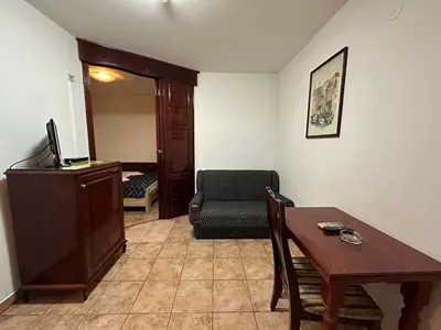 a living room with a table and a chair at Beatrix Lux Hotel in Budva