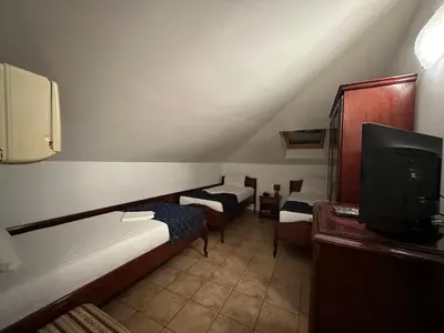 a small room with two beds and a tv at Beatrix Lux Hotel in Budva