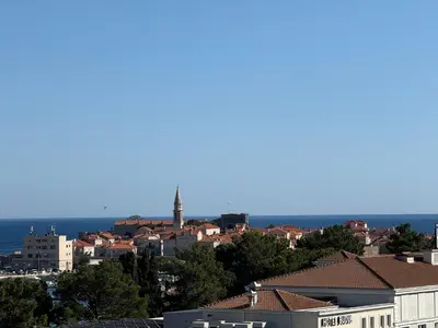 a view of a city with buildings and the ocean at Seabreeze apartments Budva in Budva
