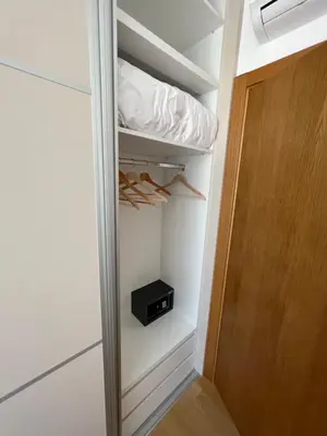 a walk in closet with a black appliance in it at Seabreeze apartments Budva in Budva
