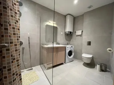a bathroom with a washing machine and a toilet at Seabreeze apartments Budva in Budva