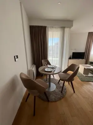 a living room with a table and chairs at Seabreeze apartments Budva in Budva