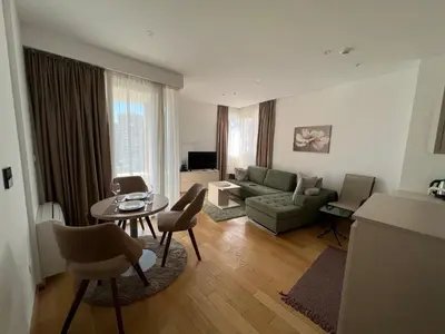 a living room with a couch and a table at Seabreeze apartments Budva in Budva
