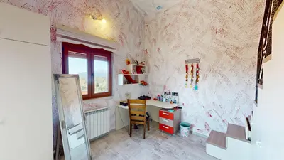 a room with a pink wall with a desk and a window at Sunny Villa in Kavac in Tivat