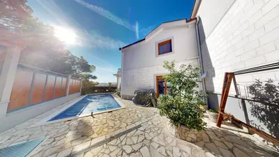 a house with a swimming pool next to a building at Sunny Villa in Kavac in Tivat