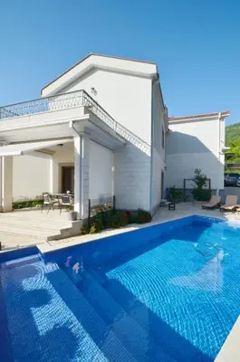 a swimming pool in front of a house at Sunny Villa in Kavac in Tivat