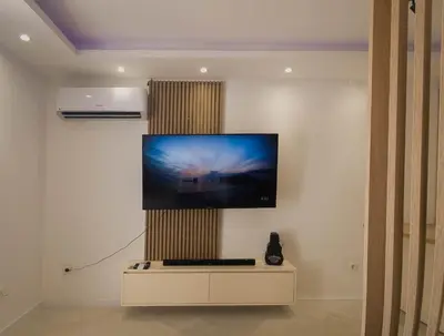 a flat screen tv on a wall in a room at SereneHaven in Kotor