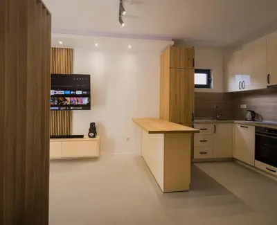 a kitchen with white cabinets and a wooden counter top at SereneHaven in Kotor