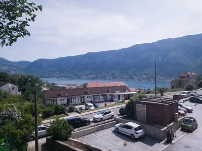 a view of a town with cars parked in a parking lot at SereneHaven in Kotor