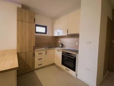 a small kitchen with white cabinets and a sink at SereneHaven in Kotor