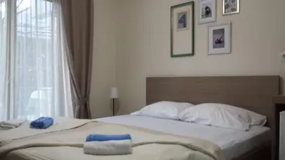 a bedroom with a bed with two towels on it at Apartments Fortunella in Budva